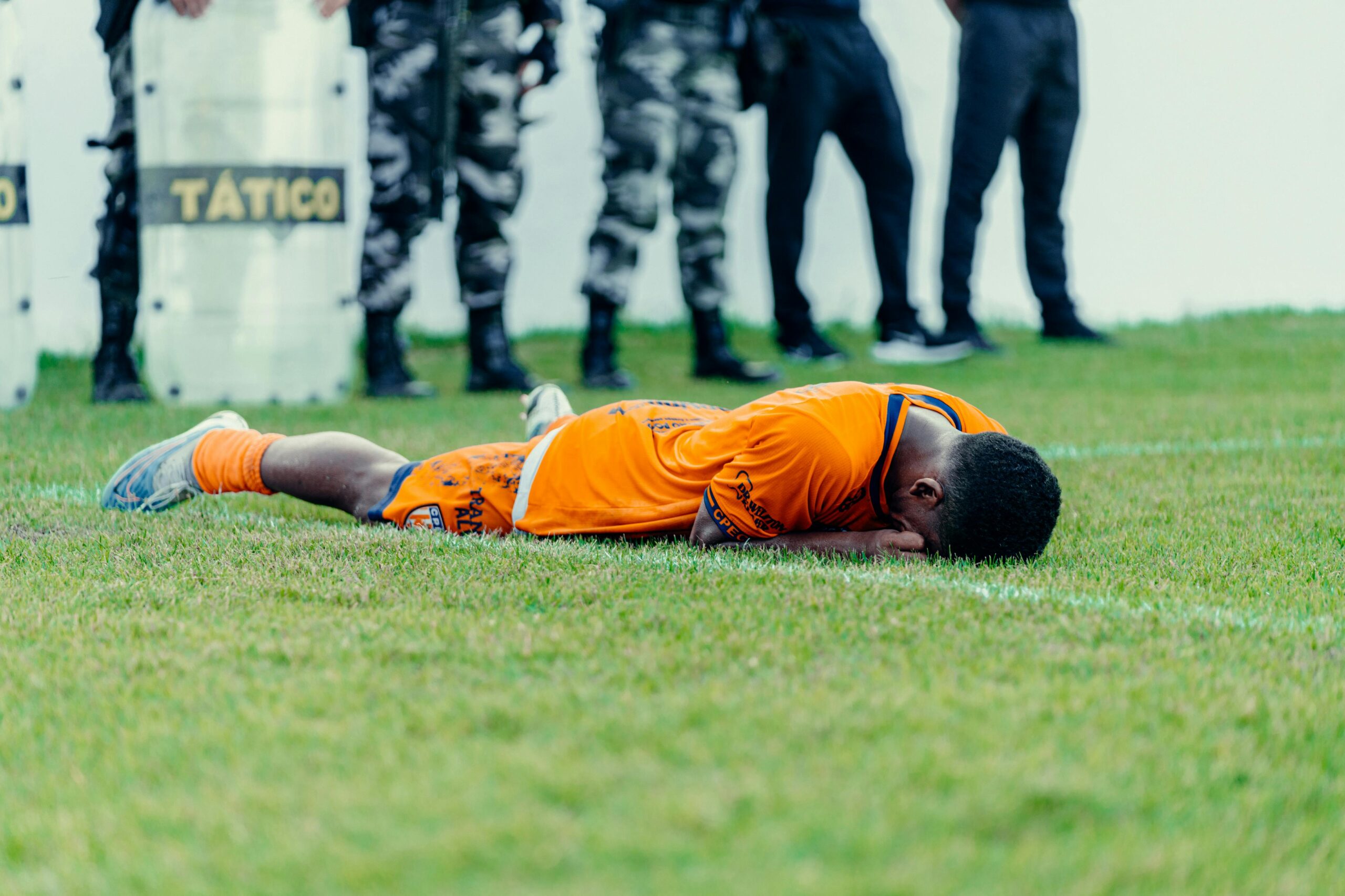 Injured Player Lying on Football Pitch